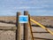 Covid-19 informational sign posted on a wooden fencepost in the Nevada