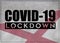 COVID-19 lockdown and prevention concept against the coronavirus outbreak and pandemic. Text writed with background of waving flag
