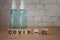 COVID-19 name of Coronavirus text on wood block and alcohol spray