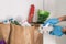 COVID-19: Is it necessary to clean your groceries delivered at home. Man in quarantine wiping cardboard package with