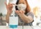 Covid-19 outbreak, coronavirus pandemic prevention with woman wearing n95 face mask cleaning hand using alcohol gel sanitizer