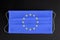 Covid-19 outbreak in Europe. Coronavirus update in European Union. Flag of EU printed on medical mask on black background.