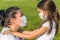 Covid-19 pandemic concept. Young mother and little daughter portrait outdoors wearing medical masks