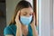 COVID-19 Pandemic Coronavirus Close up Sick Woman Headache Home Quarantine Wearing Surgical Mask Against SARS-CoV-2. Girl with