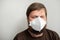 COVID-19 Pandemic Coronavirus. Portrait of a man with a beard in a white mask