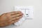 COVID-19 Pandemic Coronavirus Woman Hand Disinfect Light Switches with Wet Wipes Alcohol Cleaning Against Coronavirus Disease 2019