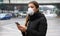 COVID-19 Pandemic Coronavirus Young Woman using Mobile Application Wearing Face Mask on Smart Phone App in City Street