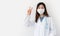 Covid-19 pandemic prevention concept. Cheerful young female physician shows victory sign