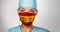 COVID-19 pandemic in Spain Asian doctor with spanish flag print on surgical mask. Happy confident woman medical nurse