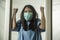 Covid-19 pandemic - young scared and frightened Asian woman in medical mask isolated suffering lockdown and quarantine during