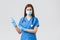 Covid-19, preventing virus, health, healthcare workers and quarantine concept. Angry concerned female nurse in blue