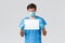 Covid-19, quarantine, hospitals and healthcare workers concept. Surprised and intrigued doctor in medical mask, scrubs