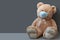 COVID-19 quarantine. Teddy bear wearing protective mask on gray background. Selective focus. Flu, illness, pandemic concept