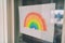 Covid-19 Rainbow children painting hanging in window as social media hope message to spread positivity in community for