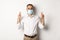 Covid-19, social distancing and quarantine concept. Hopeful employee in medical mask, holding fingers crossed and making