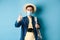 Covid-19 and summer holidays concept. Cheerful tourist in straw hat and medical mask praise and recommend good vacation
