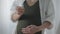 Covid-19 vaccine in hand of unrecognizable blurred pregnant woman standing indoors. Young Caucasian expectant