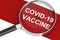 Covid-19 vaccine word under magnifying glass