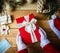 Covid Closeup shot of Santa hands in white gloves holding a Christmas present, decorations, and a sanitary mask