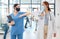 Covid healthcare doctor and nurse greeting with elbow in hospital clinic. Medical women or people with face mask and
