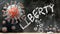 Covid and liberty - covid-19 viruses breaking and destroying liberty written on a school blackboard, 3d illustration