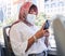 Covid, muslim and bus woman on a phone with face mask reading corona virus update, compliance news and social media