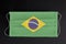 Covid outbreak in Brazil. Coronavirus update in Brazil. Brazilian flag printed on medical mask on black background