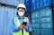 Covid, supply chain logistics and phone with a woman shipping worker managing an online order on a container dock. Stock