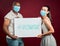 Covid vaccinated African american man and mixed race woman showing and holding poster. Two people wearing surgical face