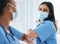 Covid, women and doctors elbow greeting in surgical mask at hospital or clinic during the pandemic. Teamwork, healthcare