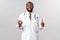 Covid19, pandemic and online medicine concept. Handsome smiling african-american doctor show thumb-up, hold smartphone