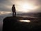 Cow girl in cowboy hat on mountain peak look into heavy mist