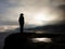 Cow girl in cowboy hat on mountain peak look into heavy mist