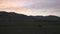 Cow grazing on meadow. Cattle on a mountain pasture on sunset. Green meadow and cow, summer landscape.