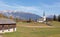 Cow grazing at pastures near church in mountain village Versam