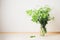 Cow parsley flowers in a glass jar on the table