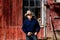 Cowboy at Barn Holding Belt Buckle Serious