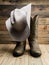 Cowboy boot and western hat on wooden