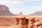 Cowboy caught in sun on rock bluff in Monument Valley Utah USA