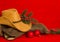 Cowboy Christmas.American West traditional boots and hat on christmas red background