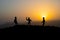 Cowboy concept. Silhouette of Cowboys at sunset time. A cowboy silhouette on a mountain with an yellow sky.