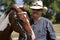 Cowboy farm rancher and horse outside