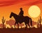 cowboy figure silhouette in horse with cows desert scene