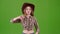 Cowboy girl is showing her finger down. Green screen