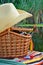 Cowboy hat, fishing tackle, towels and wicker basket, nature