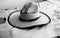 A cowboy hat sitting on a leather hide in black and white