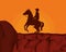 Cowboy on horse desert sunset