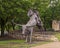 Cowboy on horseback bronze sculpture by Anita Pauwels, part of  a public art installation titled `Cattle Drive` in Central Park