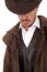 Cowboy leather coat hat looking down