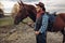 Cowboy poses with horse on texas farm